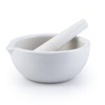 The MH-USA Mortar & Pestle, Porcelain, 130mm (320ml), features a sleek matte finish. The mortar has a spout and the pestle fits snugly inside.