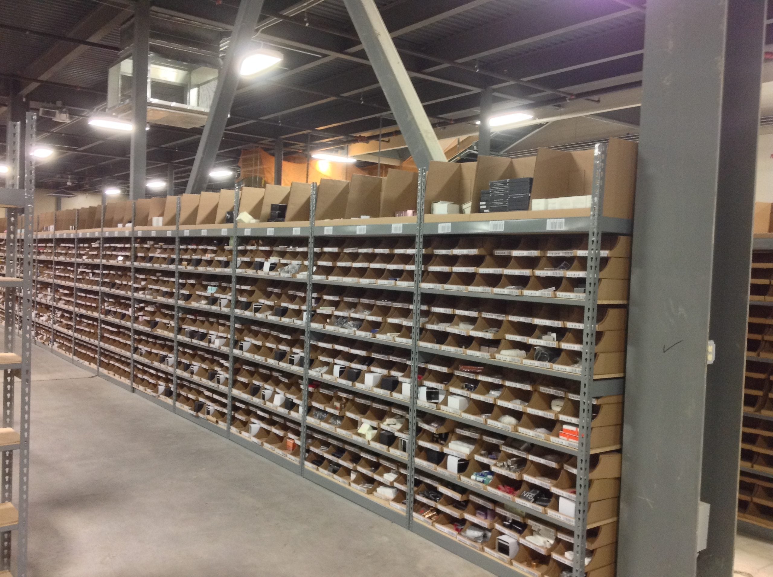 Dense rows of boltless rivet shelving holding automotive parts inventory