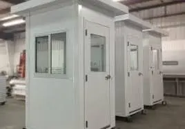 Three white security booths, resembling swab booths for virus testing, with windows and doors are lined up inside a warehouse. The booths have flat roofs and appear to be newly manufactured, boasting a clean and shiny appearance.