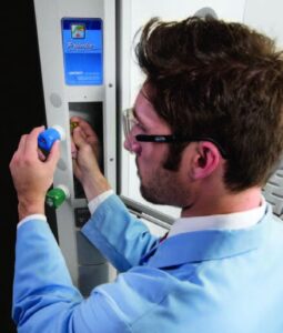Technician in a lab coat working at a premium laboratory fume hood