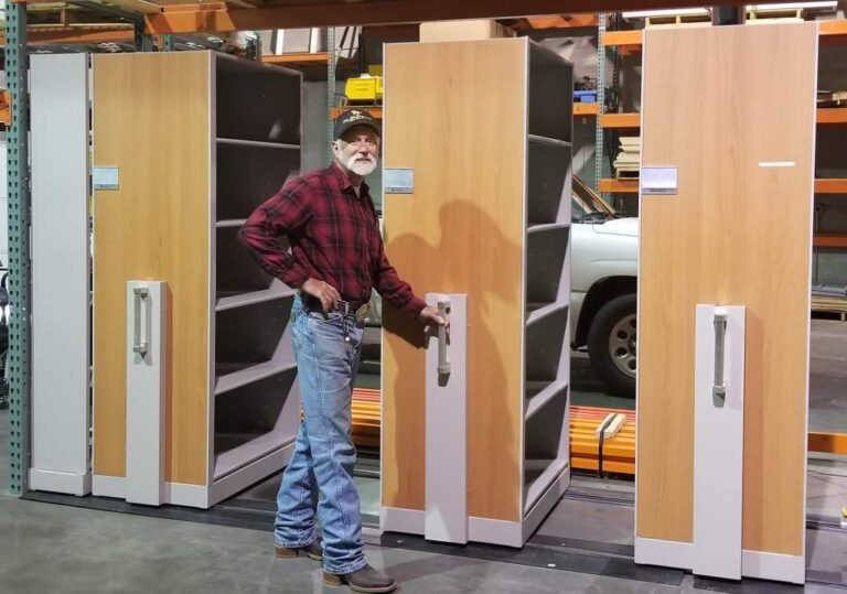 High-density mobile shelving carriages on floor tracks in a storage room