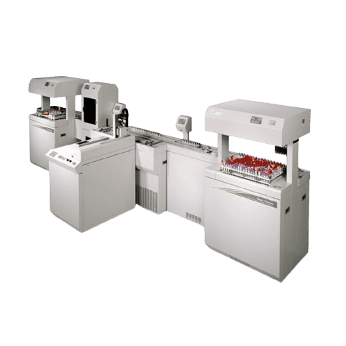 A series of gray automated lab machines, integrated into a seamless lab layout, are connected in a line. Each unit has slots filled with test tubes and features digital displays and various control panels. This specialized lab furniture is designed for processing and analyzing multiple samples efficiently.