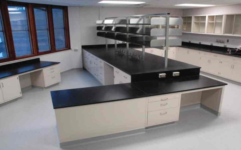 Distillery quality laboratory with central island benches, sinks and overhead shelving