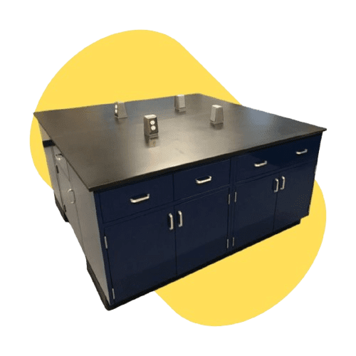 A square, dark blue laboratory workstation with a black epoxy resin countertop features customizable storage cabinets and drawers. The surface holds a few small metallic boxes, set against a stylized yellow shape, optimizing lab spaces with comprehensive planning for vocational high schools.
