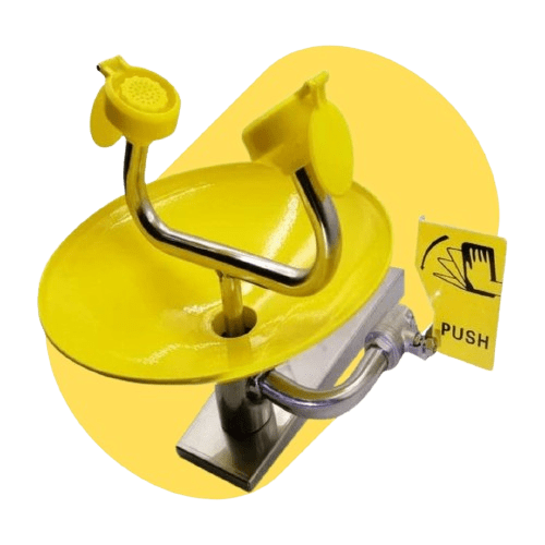 Yellow emergency eyewash station with two nozzles and a push hand symbol on a lever, perfect for enhancing laboratory safety and efficiency. The unit is mounted on a silver base, complementing premium fume hoods in lab settings.