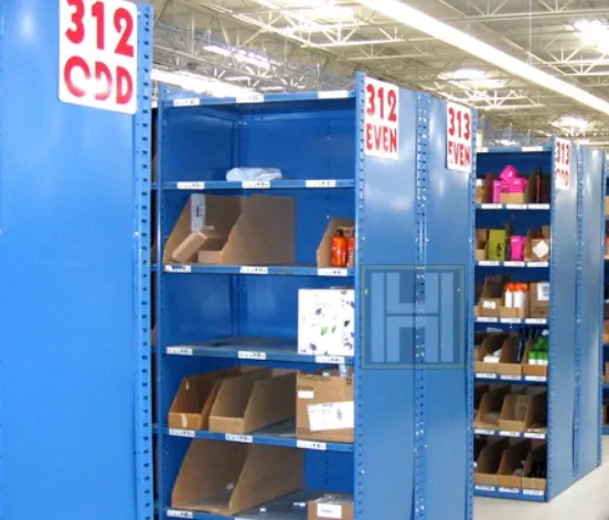 Blue metal shelving units in a warehouse are displayed under signs marked 312 COD and 312 EVEN. These sturdy metal shelves hold an array of items in cardboard boxes and plastic containers, all under the bright lights of the visible ceiling.