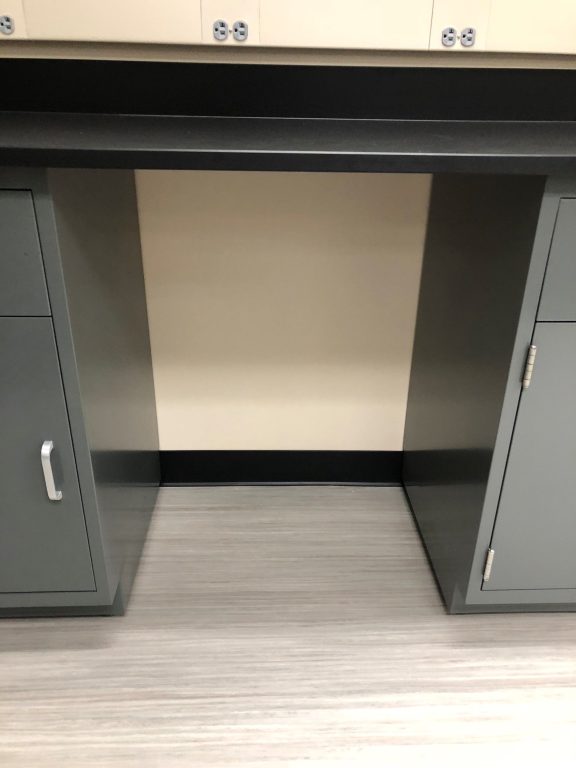 Open knee space between two drawer cabinets at a seated Weber State University lab work position