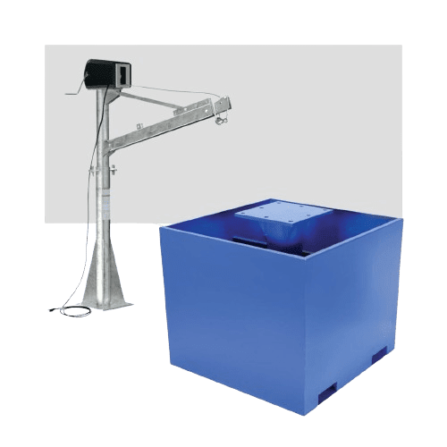 A metal industrial machine with a long arm is positioned next to a large blue square container. The machine has wires and a small box at the end of the arm. The blue container has an open top.