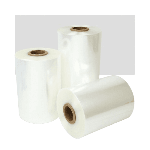 Three large rolls of transparent plastic wrap are standing against a plain background. One roll is laying horizontally, while the other two are upright, showing the brown cardboard cores inside. The plastic has a glossy finish.