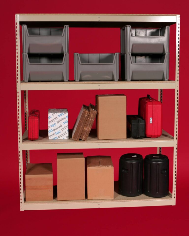 A metal shelving unit against a red background showcases the efficiency of Storage Solutions with BASC, holding gray plastic bins, a white box with text, books, brown cardboard boxes, and red and black storage cases.