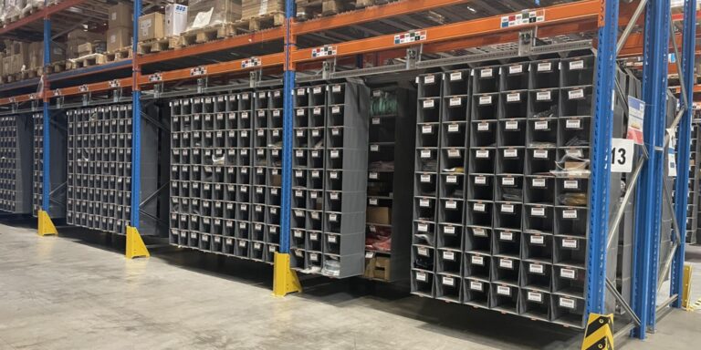 Long run of pallet rack bays filled with Storeganizer pocket columns, hundreds of pick locations per bay
