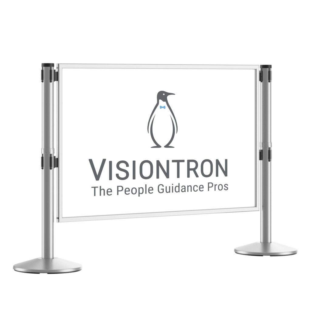A freestanding sign showcases a logo of a penguin in a bow tie, with the text VISIONTRON The People Guidance Pros. Its reminiscent of traveling with our pets, supported by two sleek metallic posts with round bases.