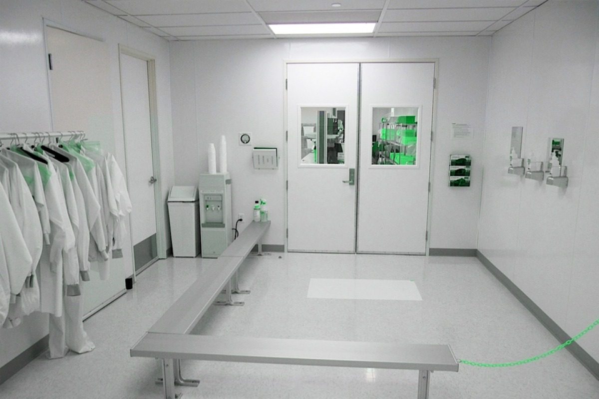 Gowning room with garment storage and a step-over bench