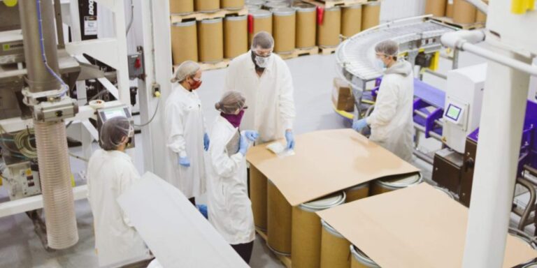Team in protective clothing working on a laboratory expansion project inside a plant