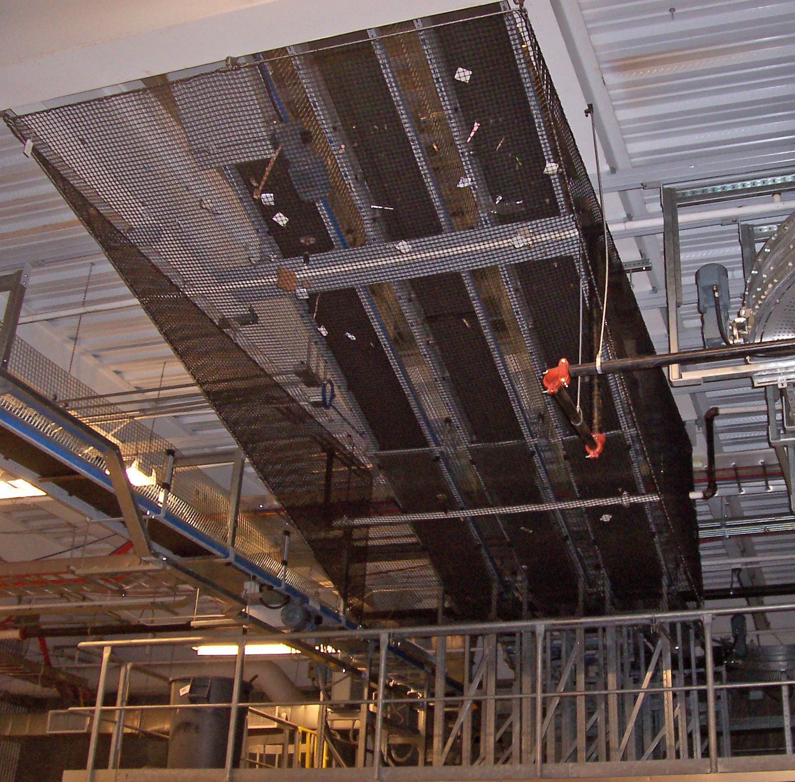 Conveyor guarding system protecting workers from moving belt and roller hazards