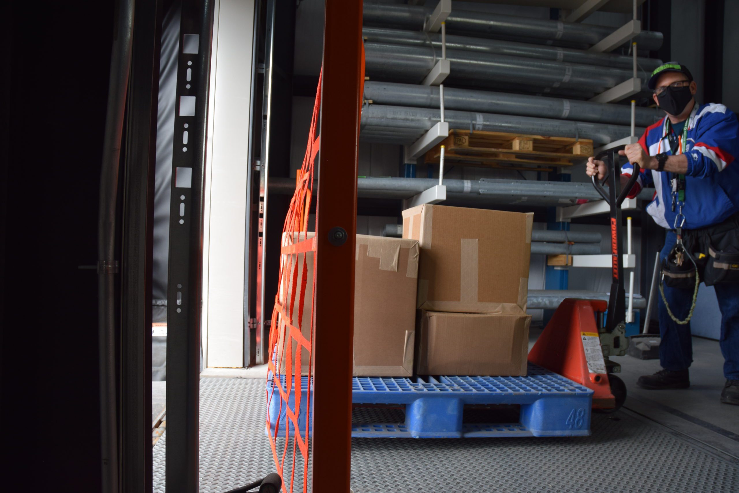 Orange dock net beside staged cartons