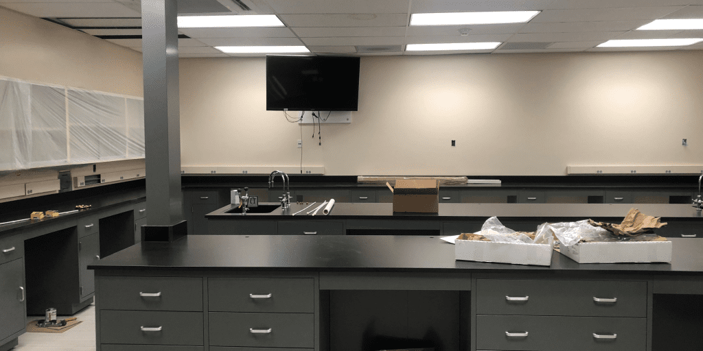 Empty laboratory fitted with dark gray phenolic resin benchtops and base cabinets