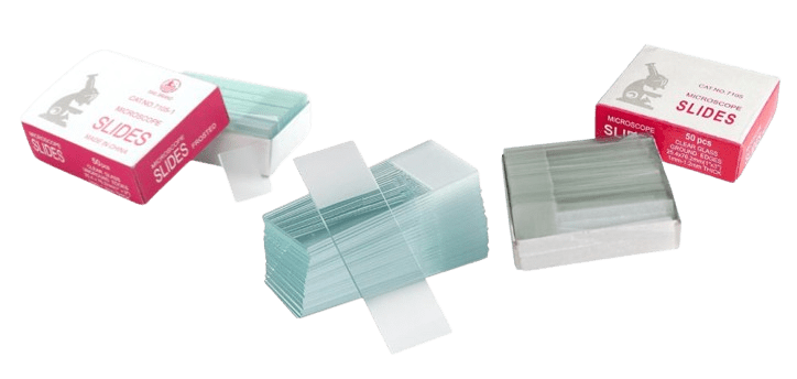 Three packages of microscope slides are displayed. Two boxes are partially open, revealing stacks wrapped in paper. The transparent, rectangular slides glisten invitingly, while the red-labeled boxes emphasize their precision-crafted quality.