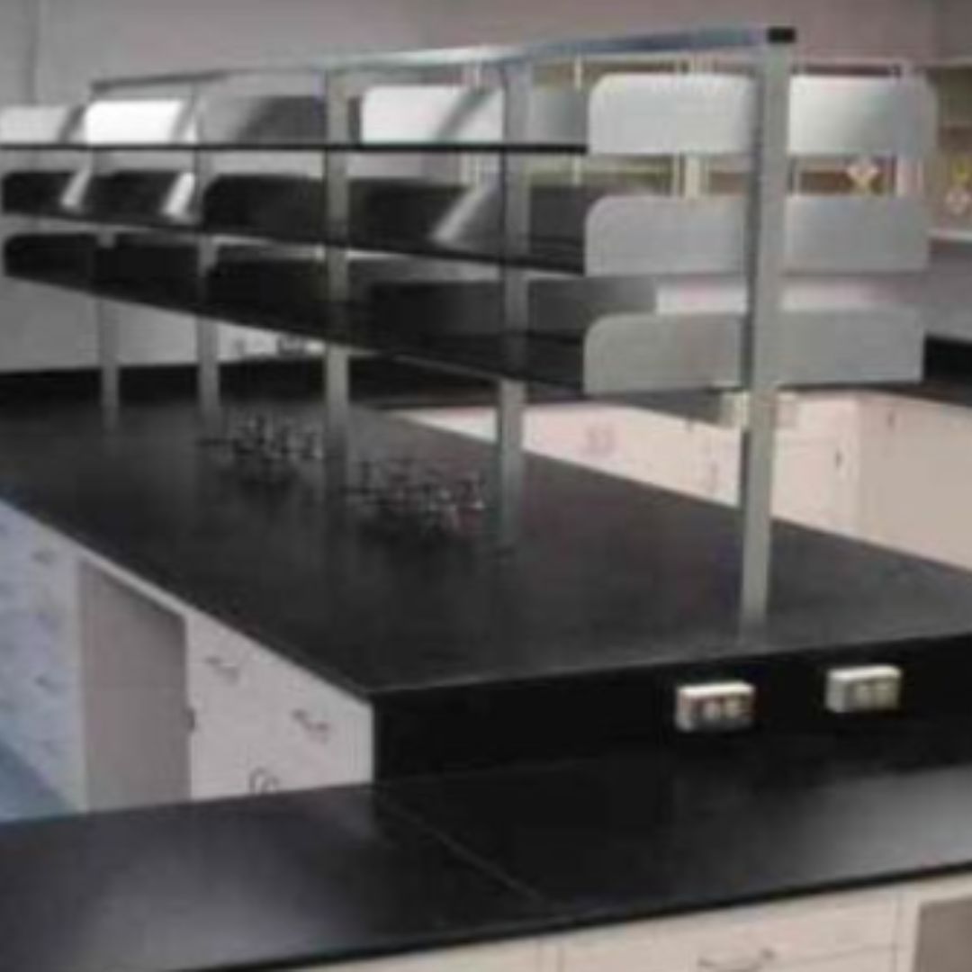 Wine and beverage quality laboratory with black counters, white cabinets and open shelving