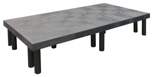 The Quantum Polymer Dunnage Rack is a solid rectangular platform with a flat gray surface and circular indentations, supported by black cylindrical legs, crafted from polyethylene with a 1900 lb. load capacity and proudly made in the USA.