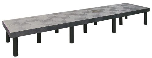 A long Quantum Polymer Dunnage Rack, featuring a solid gray surface and multiple black cylindrical legs, with an 1800 lb. load capacity, is set against a plain white background.