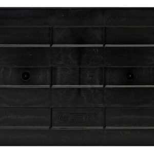 The Quantum Cross Divider is a black, rectangular plastic item with grooves and a raised border. Two circular indents and geometric patterns mark the surface. Faintly visible text and symbols confirm it’s made in the USA.