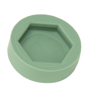 A green hexagonal Quantum Floor Glide with a raised center and 1 embossed on it, designed as non-marring floor protectors, is shown on a white background (4 per pack).