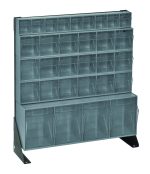 The grey plastic storage organizer includes a Quantum Tip Out Bin Floor Stand Unit with a single-sided design. It features (1) QTB304, (1) QTB309, and (3) QTB603 gray bins in a 10D x 23-5/8W x 28H black-coated finish supported by two black steel supports for stability.