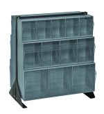 The Quantum Tip Out Bin Floor Stand, measuring 20-1/4D x 23-5/8W x 28H, includes (2) QTB303, (2) QTB304, and (2) QTB305 gray bins across three rows. Supported by durable 14 gauge steel with a black coated finish, it offers clear plastic bins for organizing items efficiently.