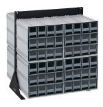 A double-sided Quantum Interlocking Storage Cabinets Floor Stand measures 24D x 23-5/8W x 28H and supports up to 750 lbs. It features a black-coated, metal frame with angled side supports, housing (96) small gray drawers with darker handles and contains (8) QIC-122 units.