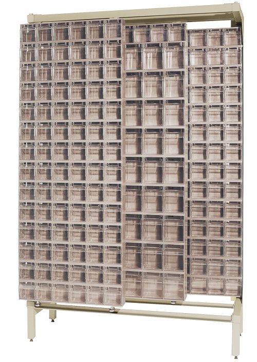 The Free Standing Slider is a large beige storage cabinet, 18D x 48W x 77H, made of tough 14-gauge steel with a 2000 lbs load capacity. It includes (9) QTB305 and (43) QTB306 tip-out ivory bins for efficient organization and accessibility.