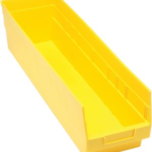 The Quantum Economy Shelf Bin is a yellow polypropylene storage bin, measuring 23-5/8W x 6-5/8D x 6H, featuring an open top, sloped front, handle, rear hanglock for nesting, seven divider slots for organizing tools or small items, and a molded-in label holder. Made in the USA.