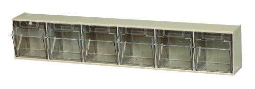 The Quantum Tip Out Bin features a durable beige metal design with a handy label slot and six clear plastic compartments arranged horizontally. Each bin opens to a 45° angle for easy access, blending simplicity and functionality to efficiently organize small items. Made in the USA.
