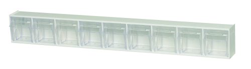 The Quantum Tip Out Bin, made in the USA, features a polystyrene white cabinet with nine clear plastic compartments that open to a 45° angle for easy access, and each has a label slot handle for organizing small items.