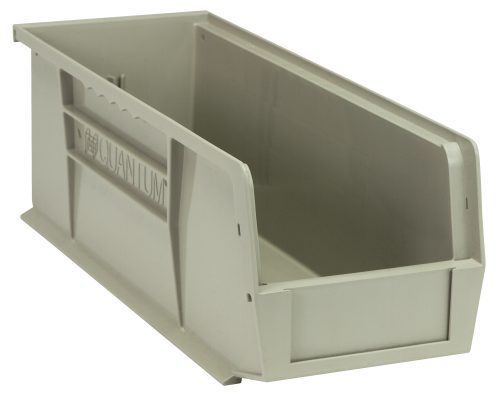 A stone-colored polypropylene Quantum Bin, 5-1/2W x 14-3/4D x 5H, features front, back, and side grips, a textured surface with Quantum embossed on the side. Includes anti-slide lock and molded-in label holder. Empty bin, angle view highlights depth.