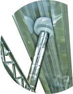 Close-up of Quantum Mobile Unit Track Rollers with a shiny cylindrical rod on a grooved track. A white circular wheel is connected to the rod, while a triangular metal framework appears partially on the left. Made in USA (set of 4).