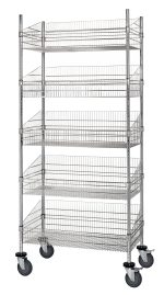 The Quantum Post Basket Cart, measuring 24W x 18D x 80H, features five chrome-plated baskets for open storage. With a robust 1200 lbs load capacity and four large wheels for easy mobility, this versatile shelving unit stands empty against a plain backdrop. Shipped KD.