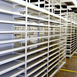 Empty metal warehouse shelves are arranged in rows, stretching into the distance like an E-Z-Rect Shelving solution. The polished concrete floor reflects the ceilings visible beams and lights, creating a stark, organized appearance ideal for efficient storage.