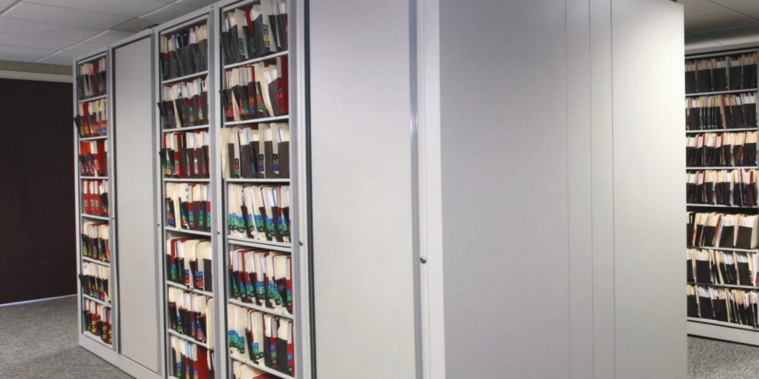 Installed Datum high-density shelving ranges filled with organized binders and records