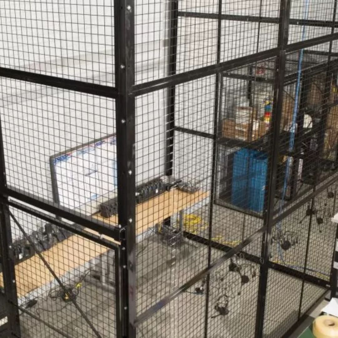 Elevated view of wire mesh partitions dividing a secure storage and work area