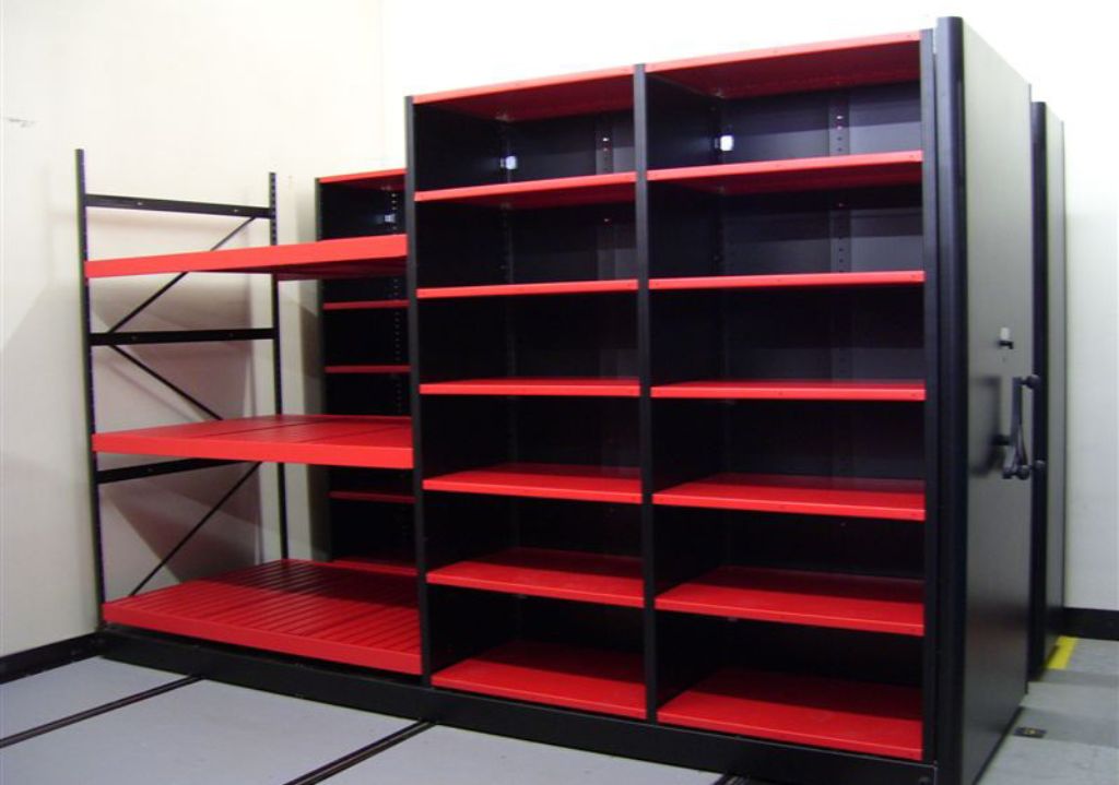 Black metal shelving units with red shelves, ideal for Equipto and Borroughs Shelving systems, are positioned against a white wall in an empty room. With several adjustable shelves, theyre perfect for adding Small Parts Organizer Bins.