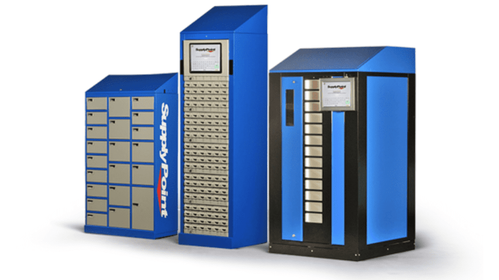 Three blue and gray industrial vending machines with SupplyPoint branding, each featuring secure compartments and a touchscreen interface for item management.