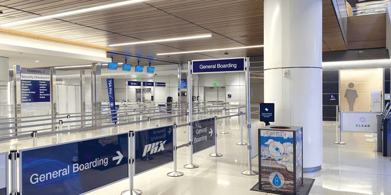 Visiontron VERSA-STAND freestanding sign stand in an airport security checkpoint area