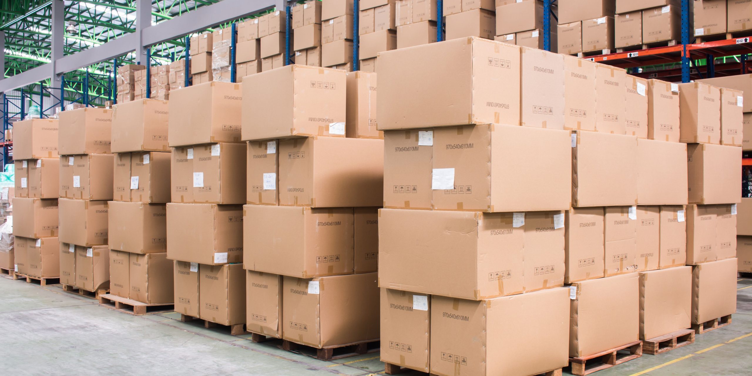 Large stacks of brown corrugated boxes arranged on wooden pallets