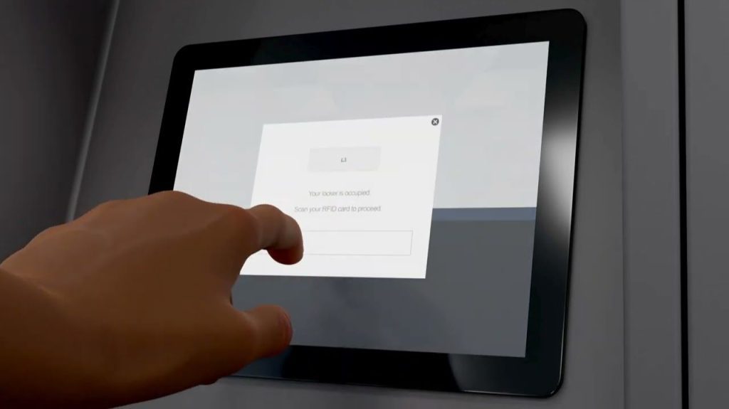 A hand reaches toward a touchscreen displaying, “Your token is accepted. Scan your RFID card to proceed,” with a blank input field—ideal for Law Enforcement Weapon Storage or Secure Armory Solutions.