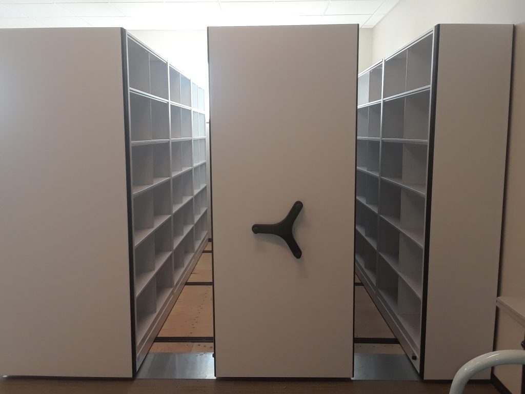 A single open access aisle between compacted Aurora mobile shelving carriages at the Mountain America facility
