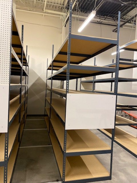 Compacted aisle between two mobile shelving carriages in the Tecovas stockroom