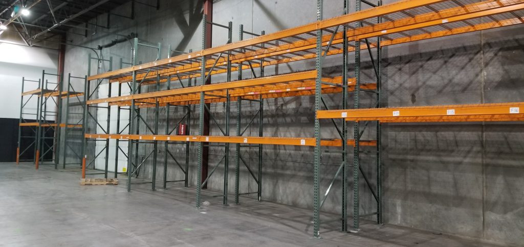 Close-up of pallet rack beam with Material Handling sticker and bay label C9 at Baileys Moving warehouse