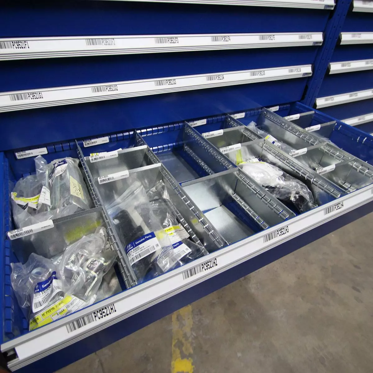 Open Borroughs modular drawer with adjustable dividers holding automotive parts and fasteners