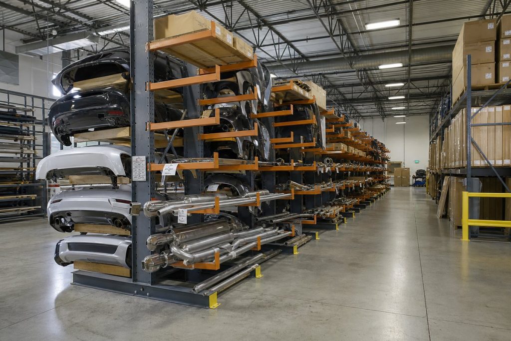 Cantilever rack storing automotive exhaust pipes and mufflers